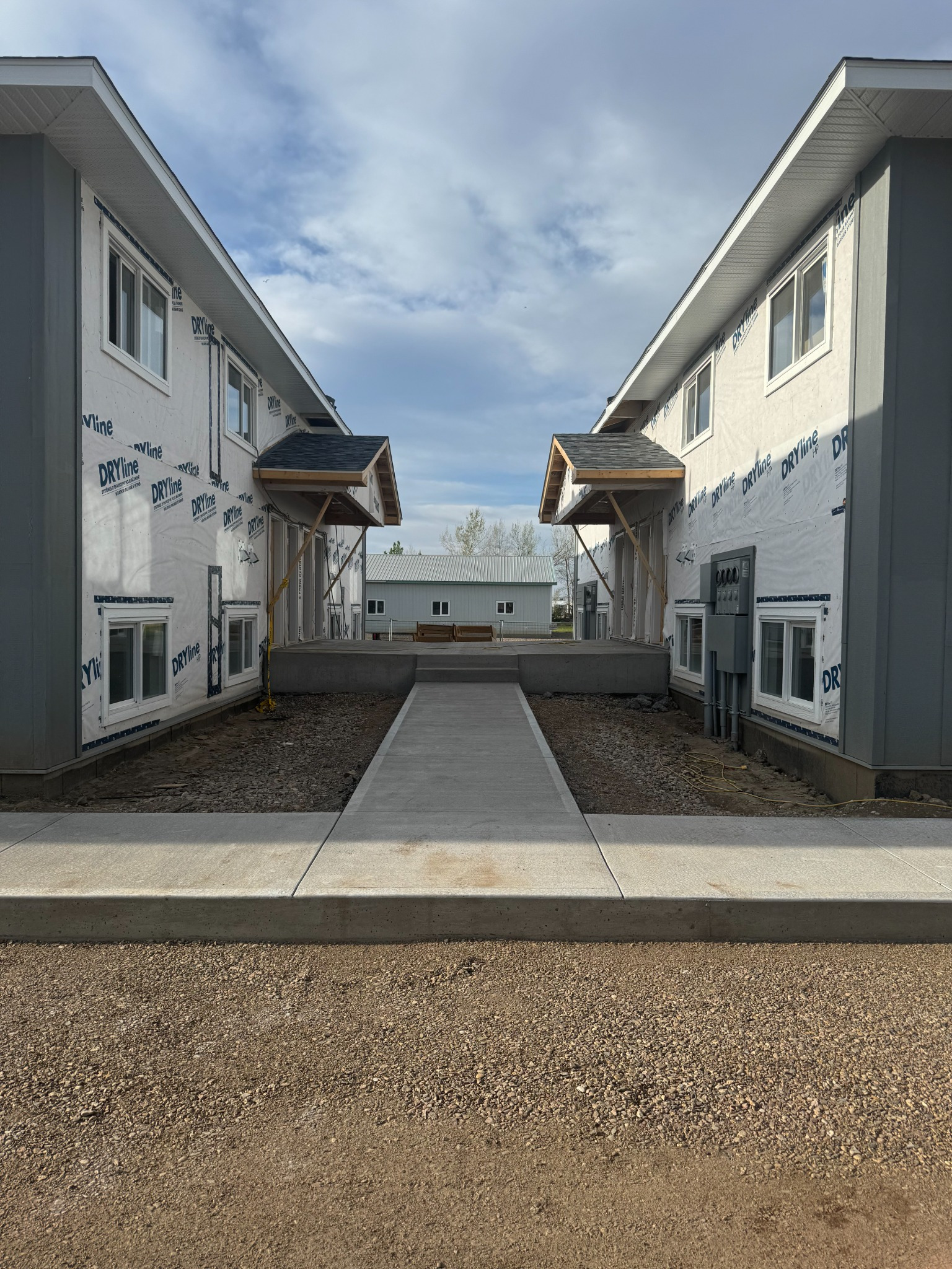 Multi-family rental development courtyard and accessible concrete walkway during construction. Multi-family rental development courtyard and accessible concrete walkway during construction.