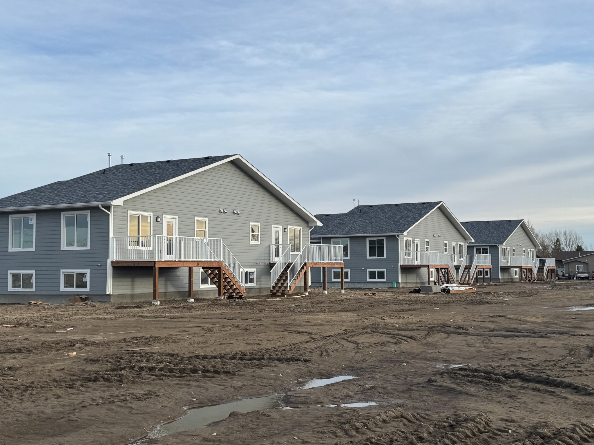 Completed multi-family rental buildings with private rear decks and individual suite access. Completed multi-family rental buildings with private rear decks and individual suite access.