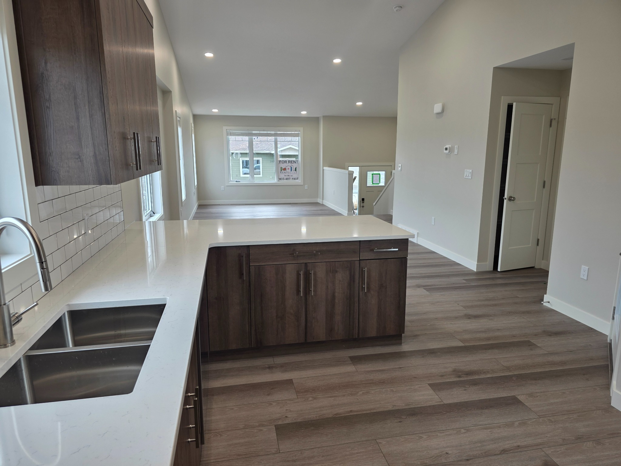 Open-concept purpose-built rental suite with a kitchen island and flexible living space. Open-concept purpose-built rental suite with a kitchen island and flexible living space.