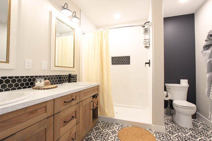 Custom Clive — bathroom with patterned floor tile, double vanity and tiled shower