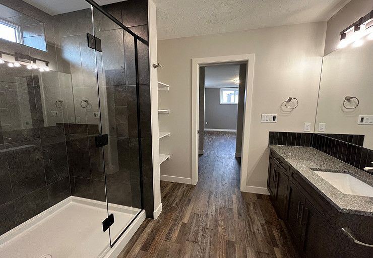 Custom Everest I Prairie Edition — finished basement bathroom with tiled glass shower