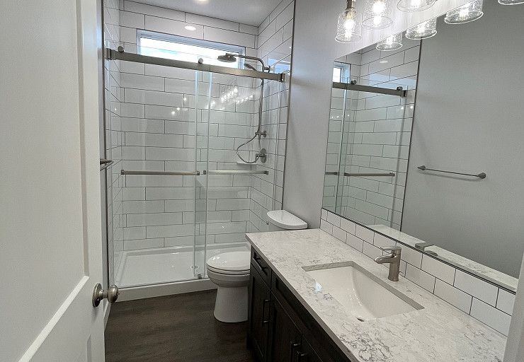Custom Everest I Prairie Edition — full bathroom with glass shower and quartz vanity