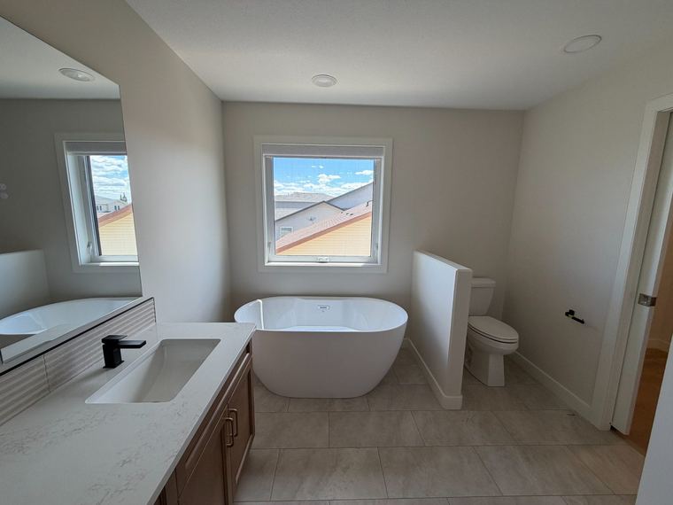 Primary ensuite with freestanding tub and private water closet