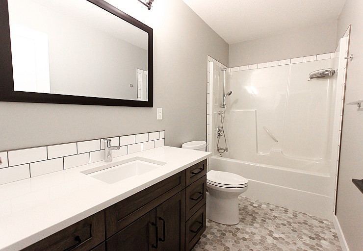 Renovation I — updated bathroom with refreshed vanity, tile and fixtures