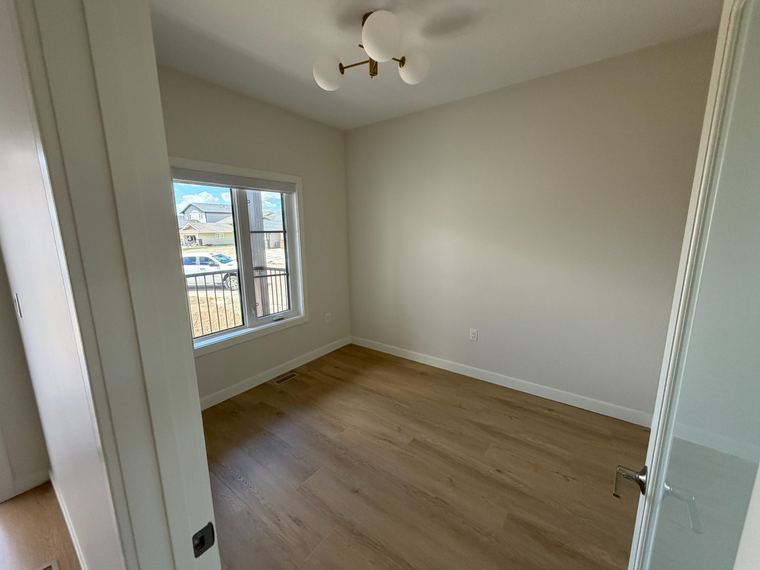 Bright finished bedroom with contemporary lighting