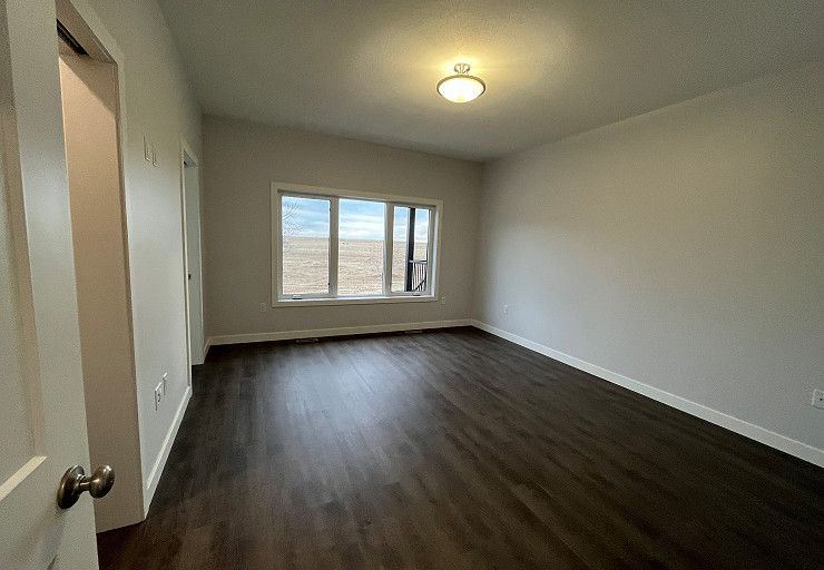 Custom Everest I Prairie Edition — bright bedroom overlooking the acreage property