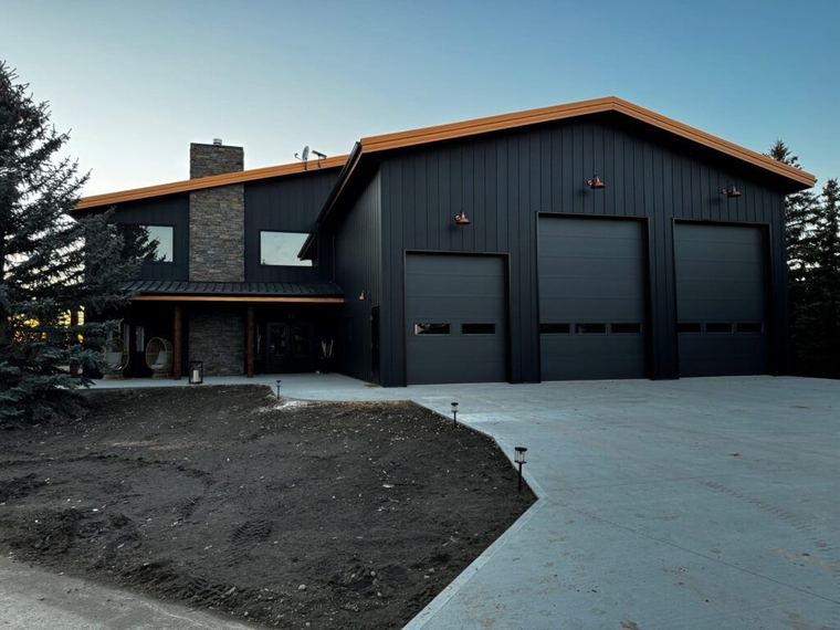 Custom Barndominium — residence and three-bay shop unified by black board-and-batten siding