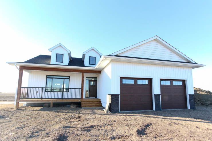 The Brant — completed on-site home with covered front deck, dormers and attached garage