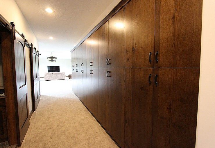 Custom Cabin — integrated storage wall serving the bedroom wing and central hallway