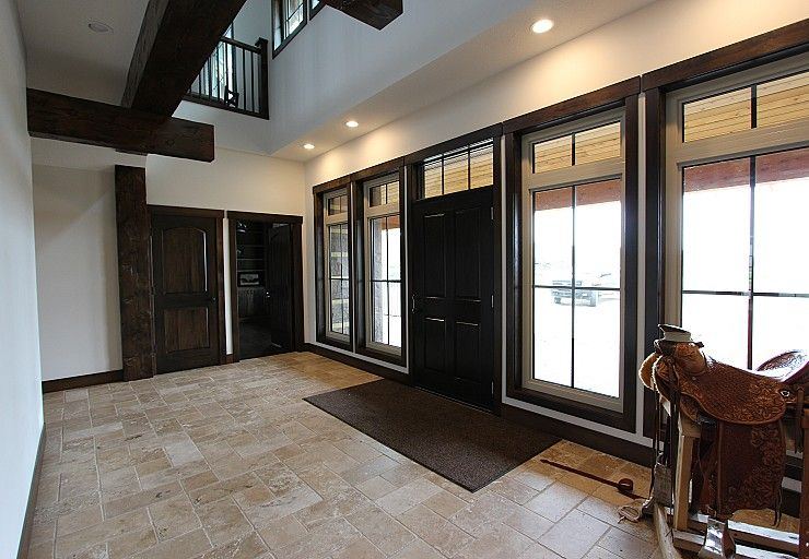 Custom Cabin — large ranch entry with durable tile flooring and timber detailing
