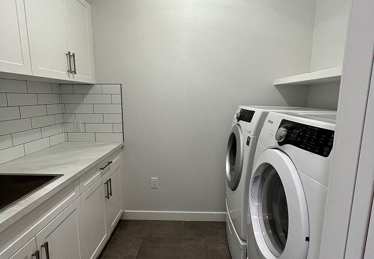Custom Everest I Prairie Edition — dedicated laundry room with cabinetry, sink and folding counter