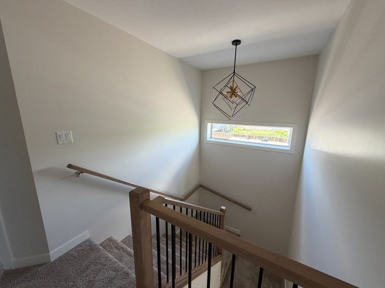 Feature stairwell with custom wood and metal railing