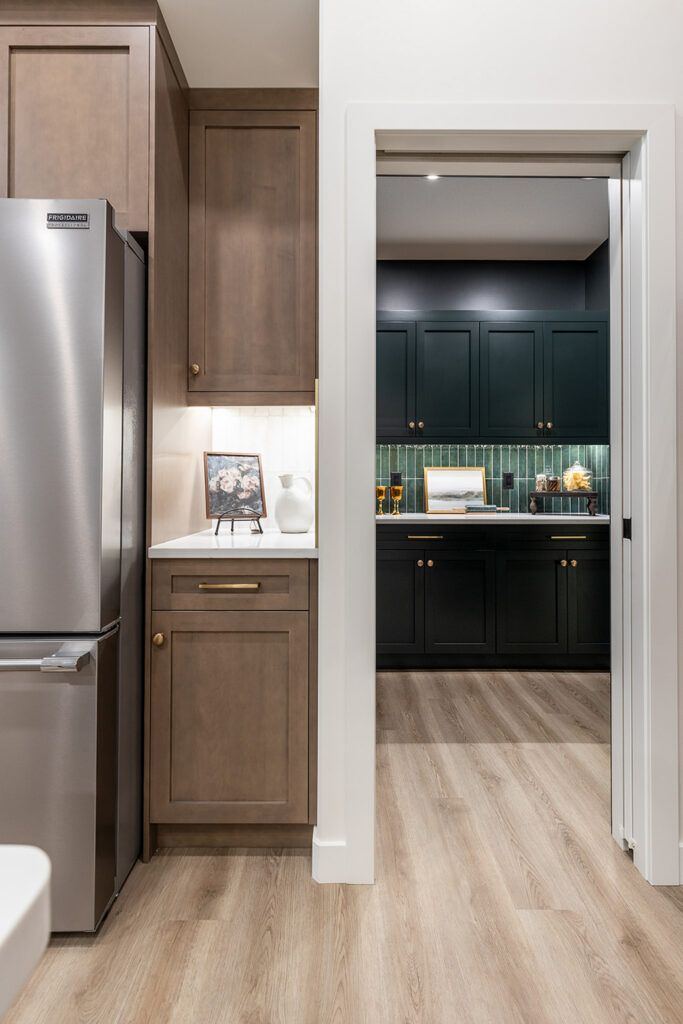 The Devon — kitchen storage wall and dedicated walk-through pantry connection