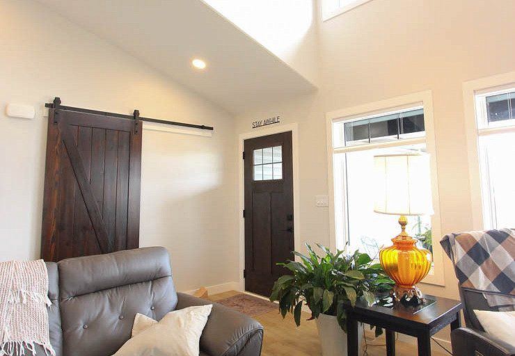 Custom Clive — welcoming front entry and living area with custom barn-door detail