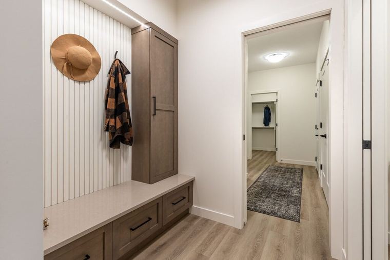 The Devon — custom mudroom bench, storage cabinetry and vertical wall detailing