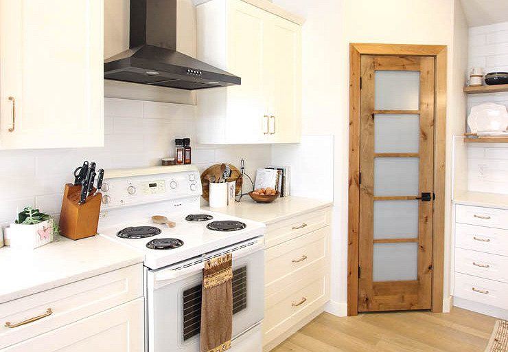 Custom Clive — white kitchen cabinetry, open shelving and rustic wood pantry door