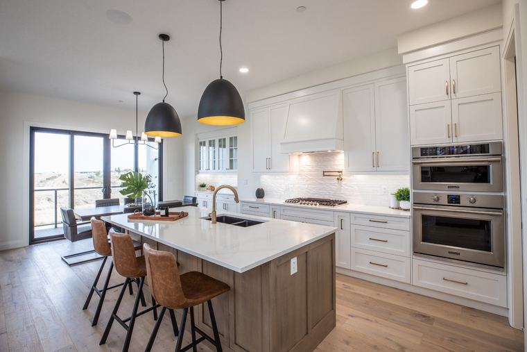 Contemporary kitchen with a warm wood island, white perimeter cabinetry, black pendant lights and integrated appliances.