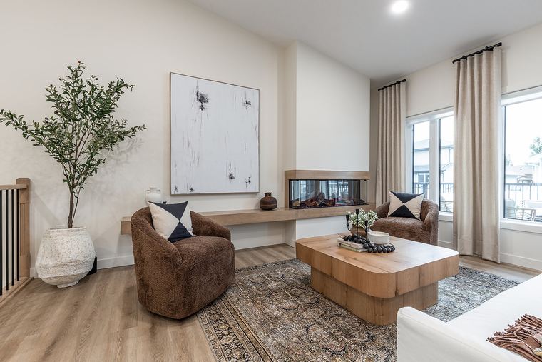 Contemporary lounge with a three-sided fireplace, custom wood ledge, large windows and layered neutral furnishings.