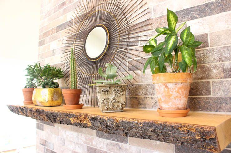 Custom Clive — live-edge fireplace mantel and brick feature detail