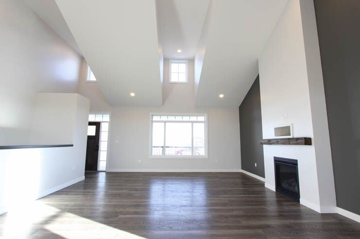 The Brant — vaulted living room with functional dormers and fireplace feature wall