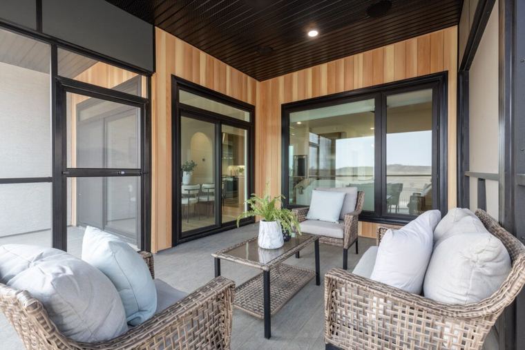 The Fairview — covered and screened outdoor living space finished in warm wood tones