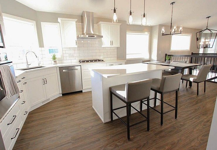 Renovation I — completed white kitchen with quartz island and connected dining area
