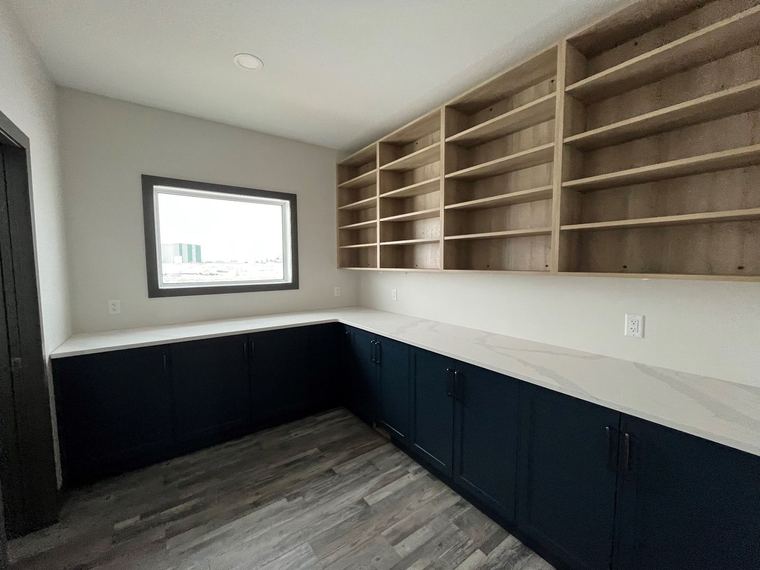 RTM home — custom hobby room or home office with extensive cabinetry and open shelving