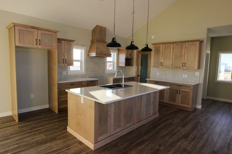 Acreage RTM — custom kitchen with full-height cabinetry and central island