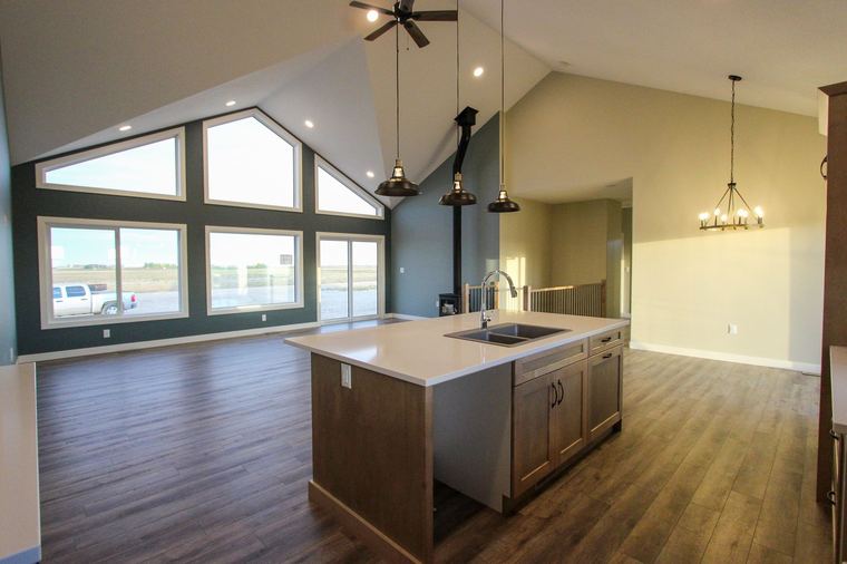 Acreage RTM — open kitchen, dining and living area beneath a vaulted ceiling