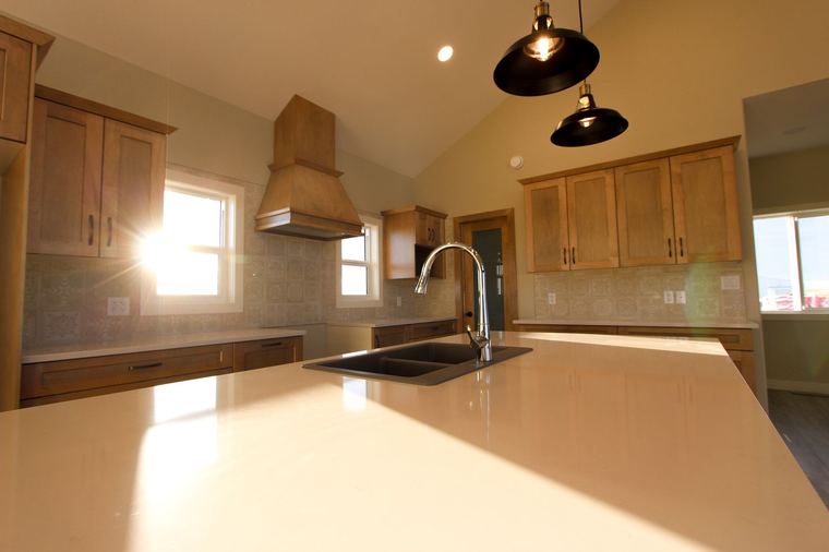 Acreage RTM — quartz island, custom cabinetry and statement pendant lighting