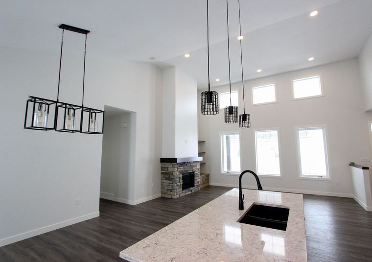 RTM showhome — kitchen, dining and living area beneath a vaulted ceiling