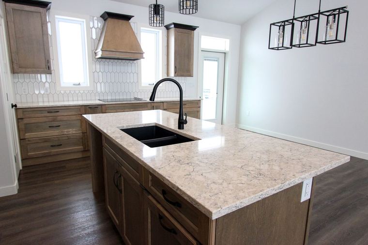 RTM showhome — quartz island and custom kitchen overlooking the great room